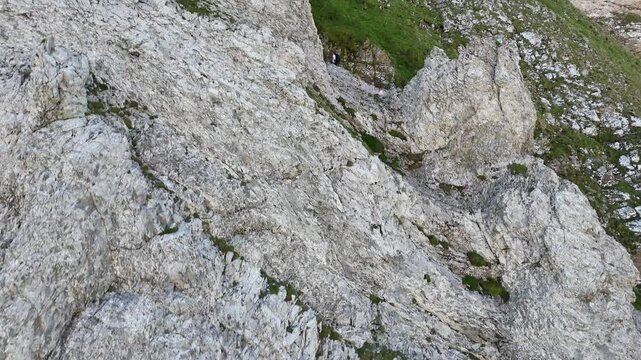 9 juli 2024, Wildhaus, Switzerland. Ascending Drone flight, view on rocky mountain cliff slope, hiking area from Rotsteinpassh&uuml;tte towards Zwinglipassh&uuml;tte. 