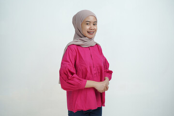 Fototapeta premium Confident Young Asian Woman in Hijab Smiling in Casual Outfit Isolated on White Background