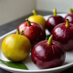 Mangosteen fruit is placed on a plate.
