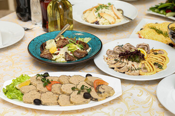 restaurant dish - stuffed fish with an orange slice and a hot salad with red meat