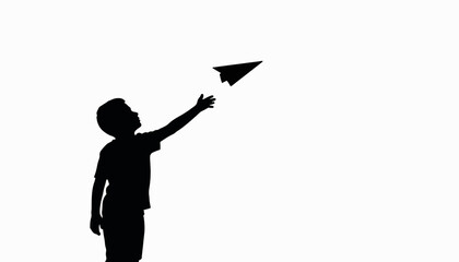Boy reaching for paper airplane silhouette, creative inspiration