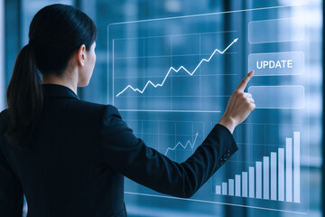 Fototapeta na wymiar A business professional interacts with an interactive digital display to update strategic growth metrics showcasing progress in financial performance and data visualization