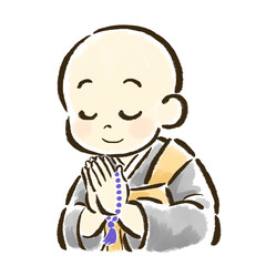 数珠を持って合掌する子どものお坊さん