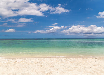 Pristine Tropical Beach with Crystal Clear Turquoise Waters Meeting White Sand under Blue Sky with Fluffy Clouds.Untouched White Sand Beach with Gradient Turquoise Ocean and Dramatic Cloud Formation