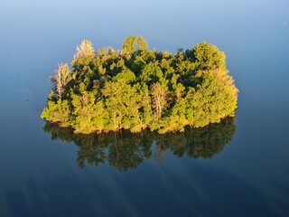 Aerial panorama of islets on large lake, enhancing biodiversity and serving as bird nesting sites in nature reserve small islands for water birds protection