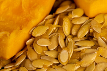 pumpkin seeds that have just been removed from a cut pumpkin close up