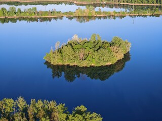 Aerial panorama of islets on large lake, enhancing biodiversity and serving as bird nesting sites in nature reserve small islands for water birds protection