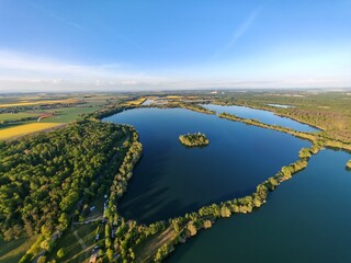 Aerial panorama of islets on large lake, enhancing biodiversity and serving as bird nesting sites in nature reserve small islands for water birds protection