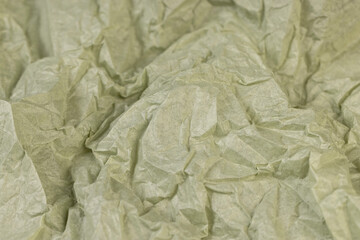 crumpled paper for packaging , part of a sheet of paper crumpled after use closeup