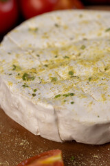 white soft cheese in salt and spices and small red round tomatoes on the table