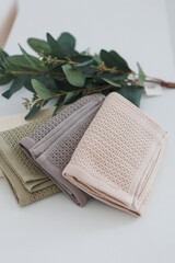 On a table, there are three towels neatly stacked one on top of the other, creating a tidy and organized appearance
