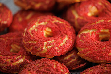 Freshly baked strawberry choux pastry rings in bakery factory