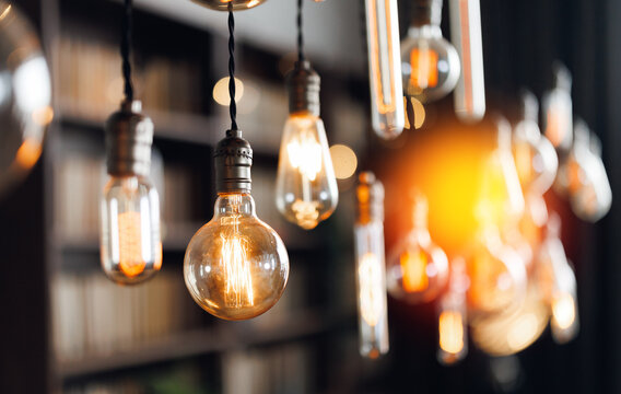 Vintage edison light bulbs illuminating a cozy library atmosphere