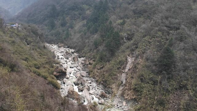 4k video footage of Himalayan mountains valley with forest and Modi River or Modi Khola, foggy and misty weather seen afar.