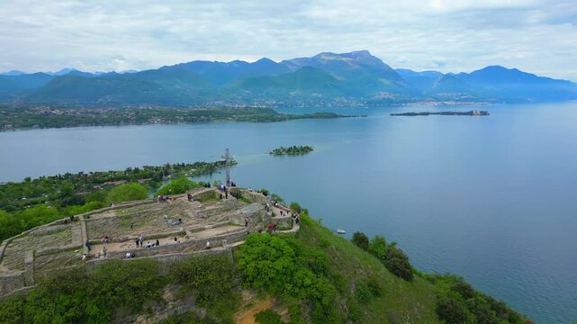 Aerial footage of the historic Rocca di Manerba fortress overlooking Lake Garda in Brescia, Italy