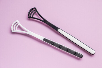 Two tongue brushes. Dental and oral care. Flat lay, top view.