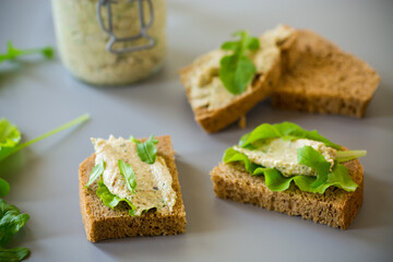 Vegetarian snack with cheese spread and fresh leaves