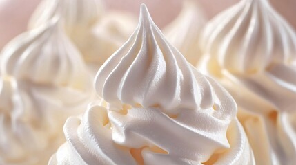 Whisk creating peaks in meringue, shiny stiff texture emphasized