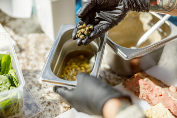 A skilled chef is meticulously preparing various fresh ingredients in a contemporary kitchen...