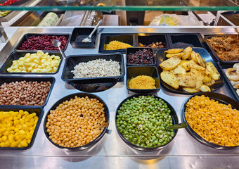 A salad bar featuring an extensive variety of fresh vegetables and fruits