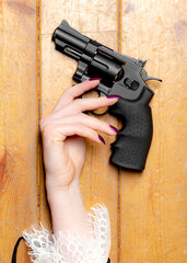 a hand with a gun on the floor