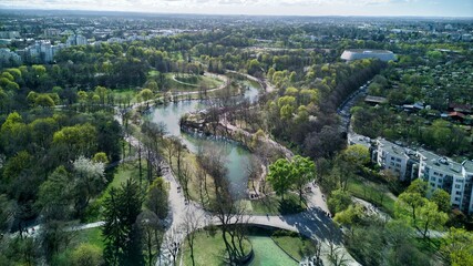 View of Westpark and part of Munich city from above. A sunny day after a rain. Aerial drone shot. Trees and bushes are still partially leafless. Spring has arrived.