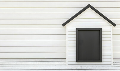 Fototapeta premium Minimalist house cutout on a white panelled wall with a black rectangle