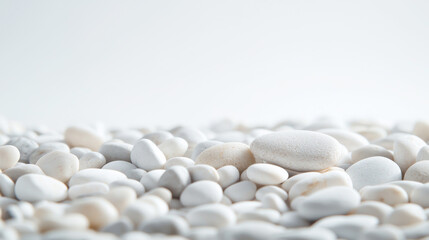 A serene collection of smooth white pebbles on a light background, ideal for decoration.
