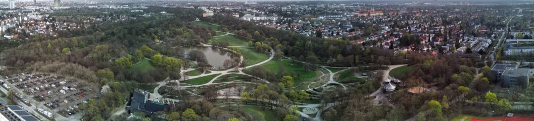 Panoramic View of Westpark and part of Munich city from above. Aerial drone shot. Trees and bushes are still partially leafless. Spring has arrived.