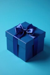 Obraz premium Navy blue gift box with satin bow, classic blue background, image, design, holiday
