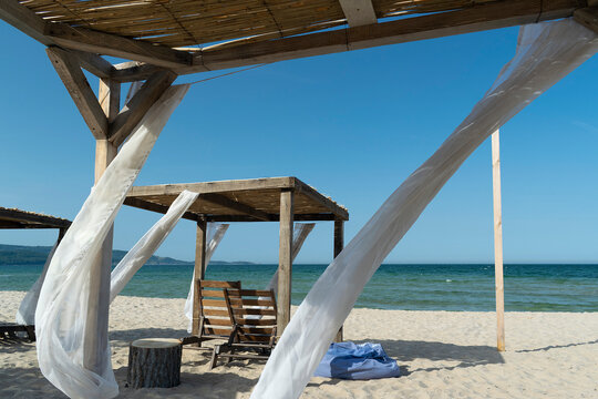 Sunny beach with wooden tent and blue sky in Bulgaria
