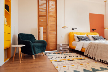 A modern bedroom with a comfortable bed and a bright yellow headboard