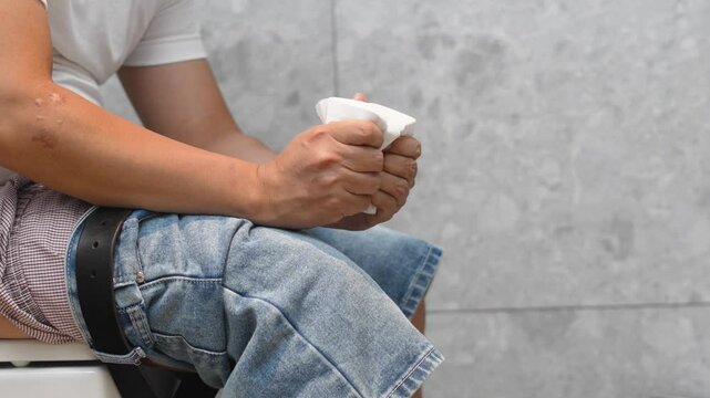 Man has diarrhea in the bathroom