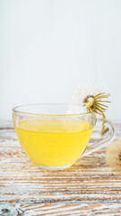 Dandelion tea in a transparent cup. Healthy herbal tea.