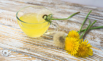 Dandelion tea in a transparent cup. Healthy herbal tea.
