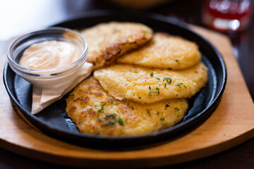 Potato pancakes with sour cream closeup. Belorussian cuisine