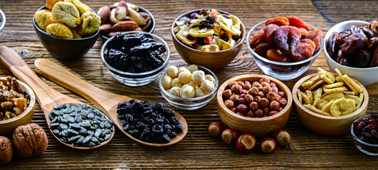 Composition with a variety of dried fruits and assorted nuts.