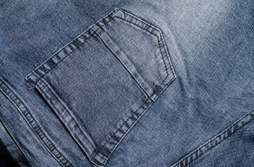Close-up of pocket on grey jeans taken in studio.