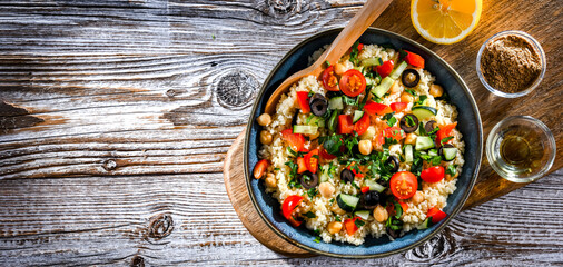 A plate of couscous served with vegetables and chickpeas