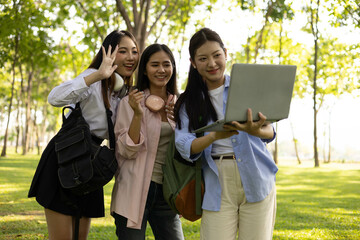 Three women are walking in a park, one of them is carrying a backpack. Scene is relaxed and casual, as the women are enjoying a leisurely walk in the park
