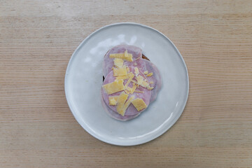 A slice of bread covered with ham and cheese.