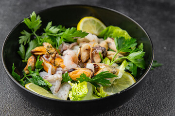 Salad seafood shrimp, mussels, squid, rapawn, prawn, green mixed leaf dish fresh food background on the table rustic food top view copy space 