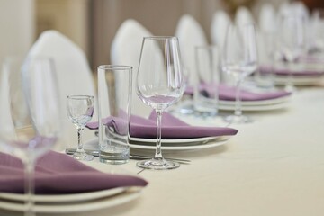 Table setting, ready for the reception of guests. Glasses for drinks on the table