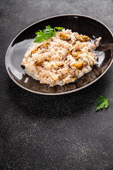 Rice seafood risotto mussel, shrimp, prawn, rapan, squid dish fresh gourmet food background on the table rustic food top view copy space