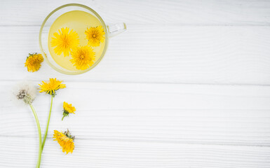 Dandelion tea in a transparent cup. Healthy herbal tea.