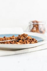 Granola or baked oat flakes with chocolate and nuts. Healthy and simple breakfast.
