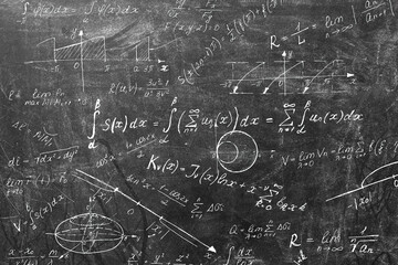 Board inscribed with scientific formulas and calculations in physics and mathematics. Science and education background.