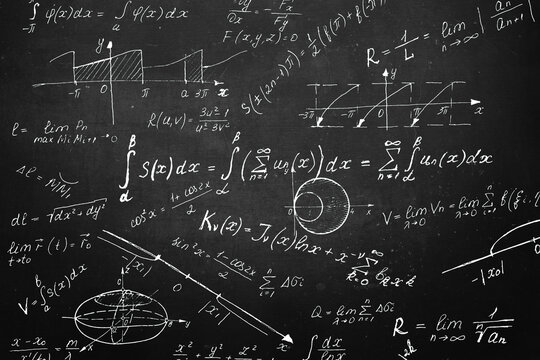 Board inscribed with scientific formulas and calculations in physics and mathematics. Science and education background.