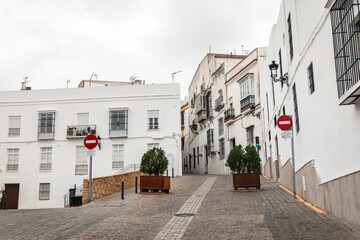 a cobbled street with typical white houses in Arcos de la Frontera, province of Cádiz, Andalusia, Spain
