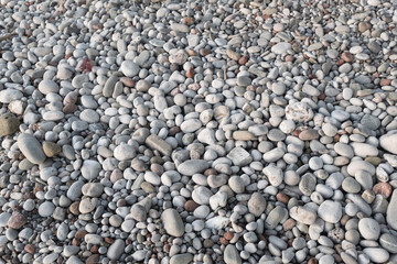 Smooth Gray and White Pebbles on Rocky Beach – Natural Background of Round Stones and Coastal Texture for Nature, Relaxation, and Design Concepts. High quality photography